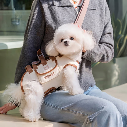 Sac de transport pour chiens beige avec un chien blanc porté par une femme